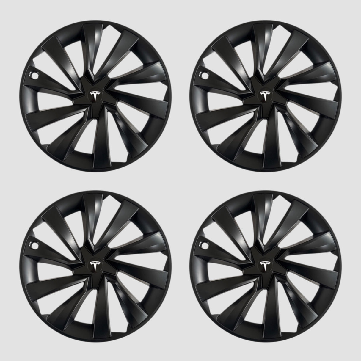 Vier schwarze MV Spiral-Radkappen mit Tesla-Logo für Model Y 2025.
