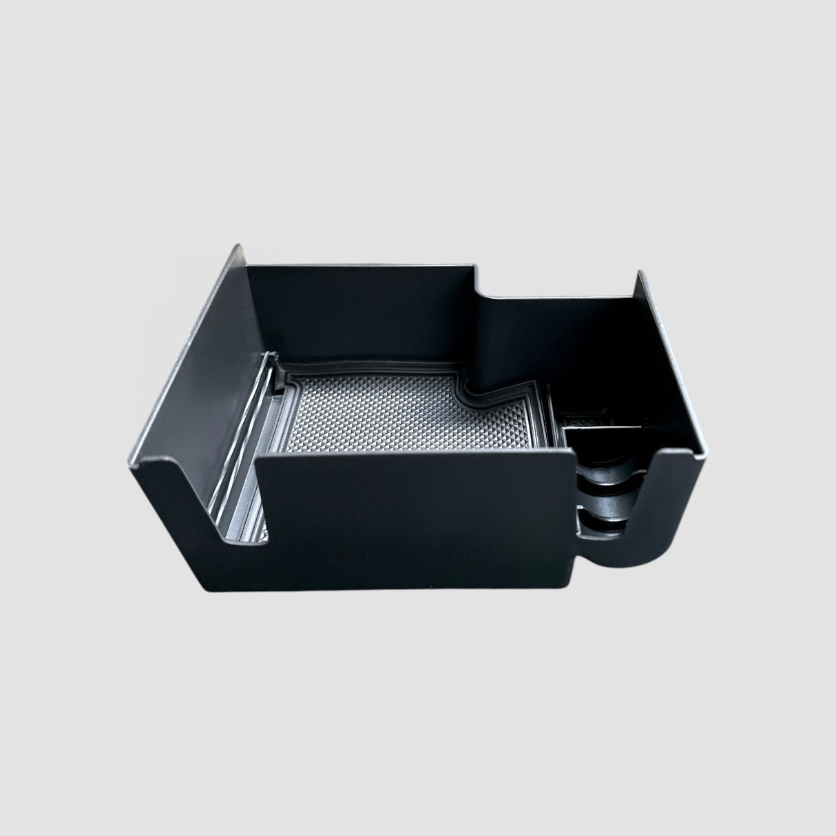 Schwarze Aufbewahrungsbox für die Armlehne des Kia EV9, entworfen zur Organisation von Kleinigkeiten im Auto.