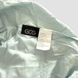 Hellblaues GCG MAX Bambus-Spannbettlaken mit Etiketten, die Waschhinweise und Produktinformationen zeigen.