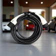 GCG MAX Ladekabel Typ 2 für Elektroautos, zusammengerollt auf Fliesenboden.