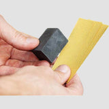 Reparaturset für Felgen mit Schleifblock und Schleifpapier zur Autopflege.