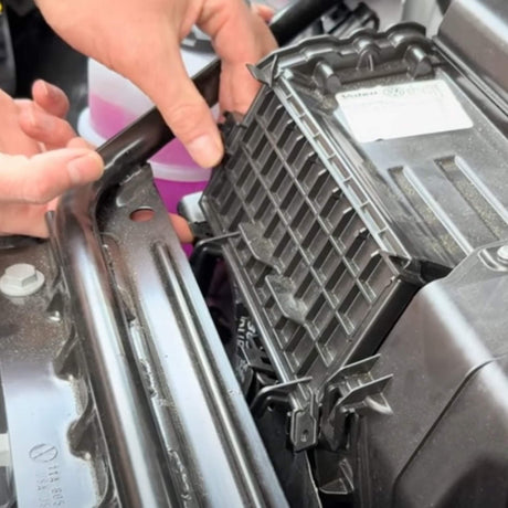 Person installiert einen Kohle-Luftfilter im Motorraum eines VW ID.3/4/5/6/7.